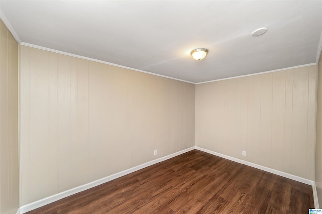 empty room featuring ornamental molding and dark wood-type flooring