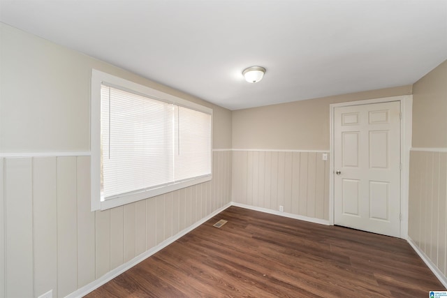 spare room with dark hardwood / wood-style flooring