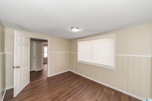 spare room featuring dark hardwood / wood-style flooring