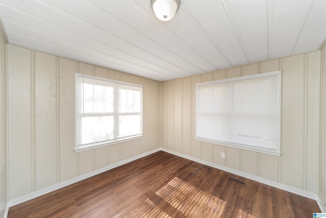 empty room with dark hardwood / wood-style flooring