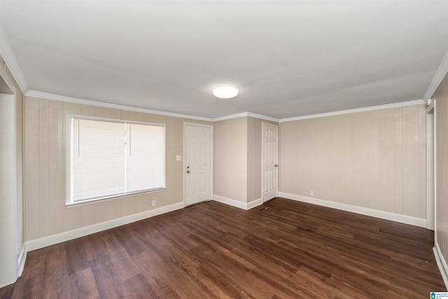 spare room with crown molding and dark wood-type flooring