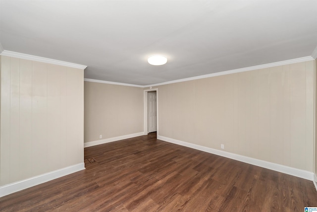 spare room featuring dark hardwood / wood-style flooring and ornamental molding