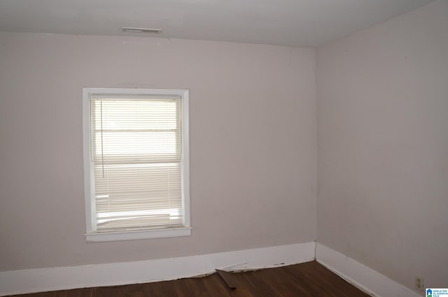 unfurnished room with dark hardwood / wood-style floors