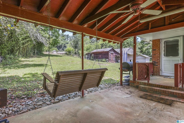 view of patio featuring ceiling fan and a storage unit