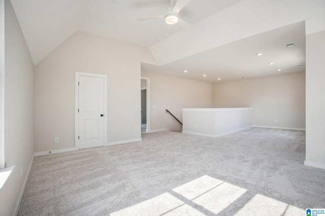 empty room featuring recessed lighting, light colored carpet, a ceiling fan, baseboards, and vaulted ceiling