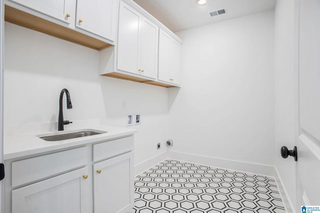 laundry room featuring hookup for a washing machine, cabinet space, visible vents, hookup for an electric dryer, and a sink