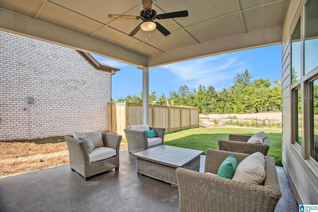 view of patio / terrace with an outdoor living space, fence, and a ceiling fan