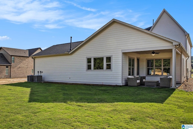 back of property with ceiling fan, central AC unit, and a lawn