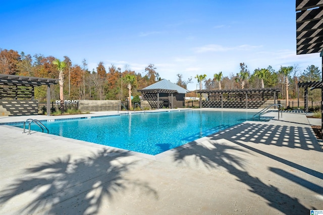 pool with a patio, fence, and a pergola