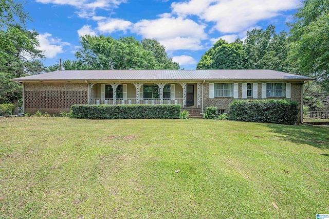 single story home with a front yard and covered porch