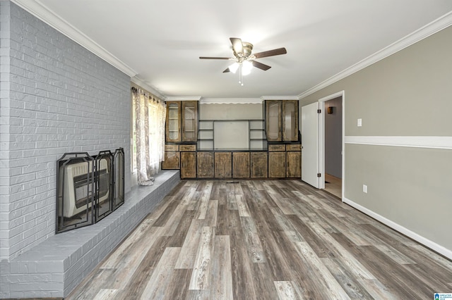 unfurnished living room featuring ornamental molding, ceiling fan, and hardwood / wood-style flooring