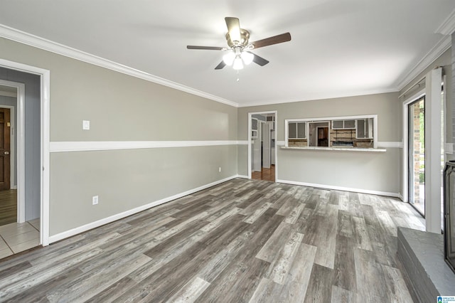 unfurnished living room featuring ceiling fan, crown molding, and wood-type flooring