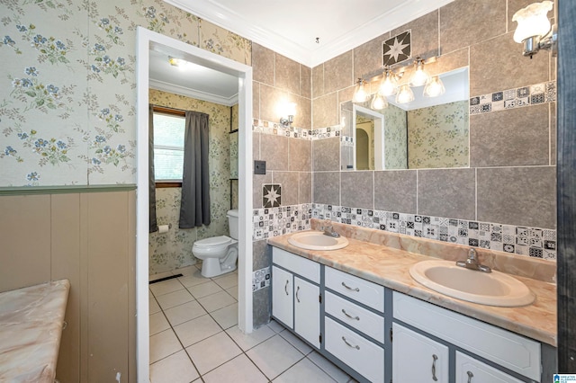 bathroom with toilet, tile walls, crown molding, tile patterned floors, and vanity