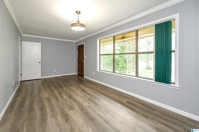 unfurnished room featuring dark hardwood / wood-style flooring and crown molding