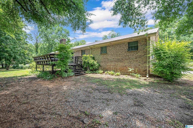 rear view of property featuring a wooden deck