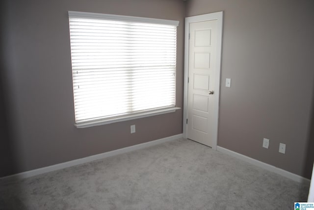 unfurnished room with light colored carpet