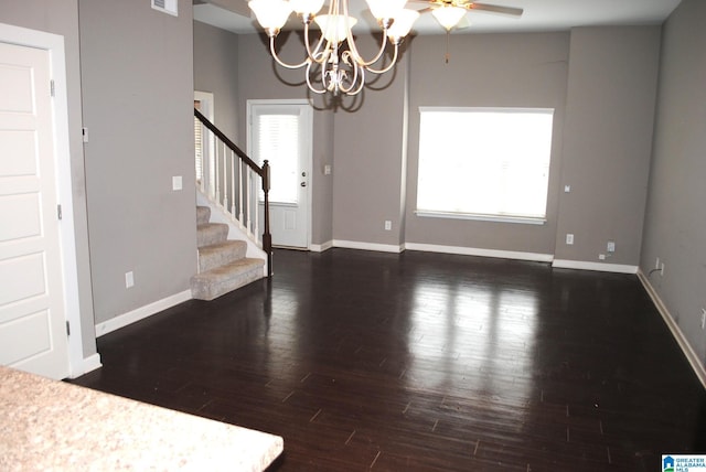 interior space featuring dark wood-type flooring and a chandelier