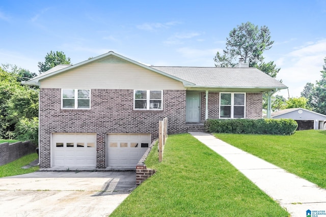 view of front of home with a garage and a front lawn