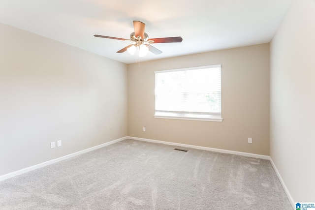 carpeted spare room with ceiling fan