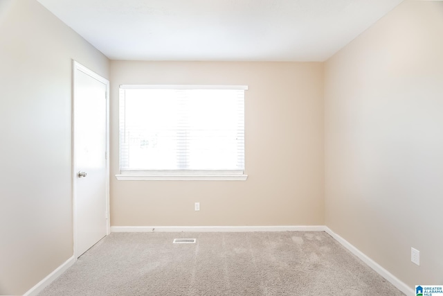 spare room with light colored carpet