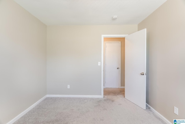 unfurnished room with light colored carpet