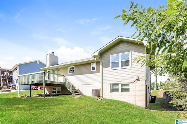 back of house with a wooden deck, a yard, and central AC unit