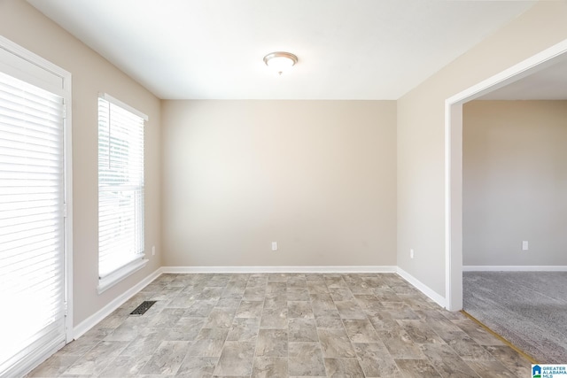 empty room featuring light colored carpet