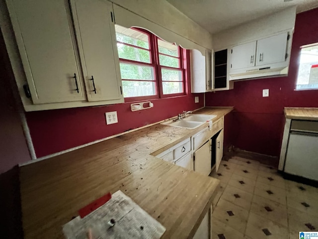 kitchen featuring sink and white cabinets