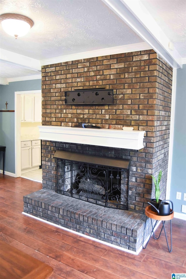 room details with a fireplace, a textured ceiling, and wood finished floors