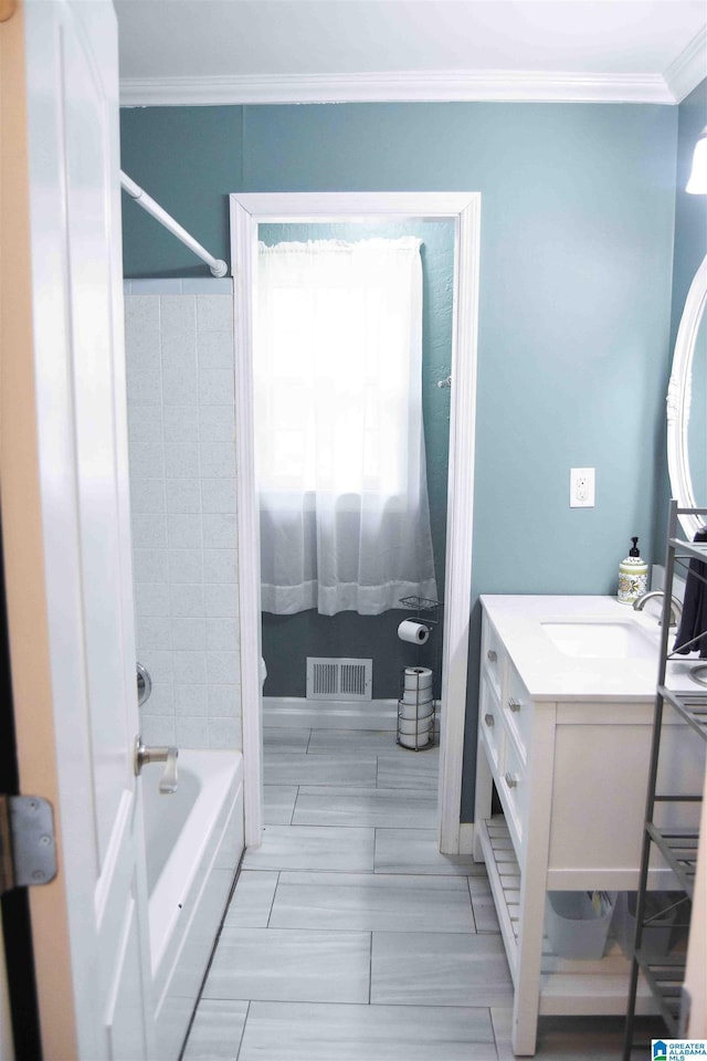 bathroom featuring ornamental molding, shower / tub combination, vanity, and visible vents