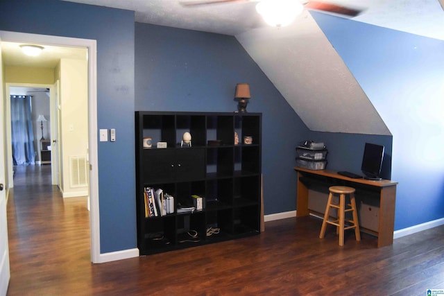 home office with lofted ceiling, visible vents, a ceiling fan, baseboards, and dark wood-style floors