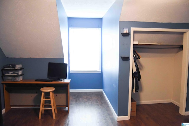 office area featuring vaulted ceiling, baseboards, and dark wood finished floors