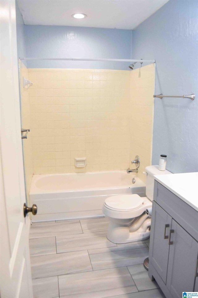 bathroom featuring toilet, tub / shower combination, and vanity