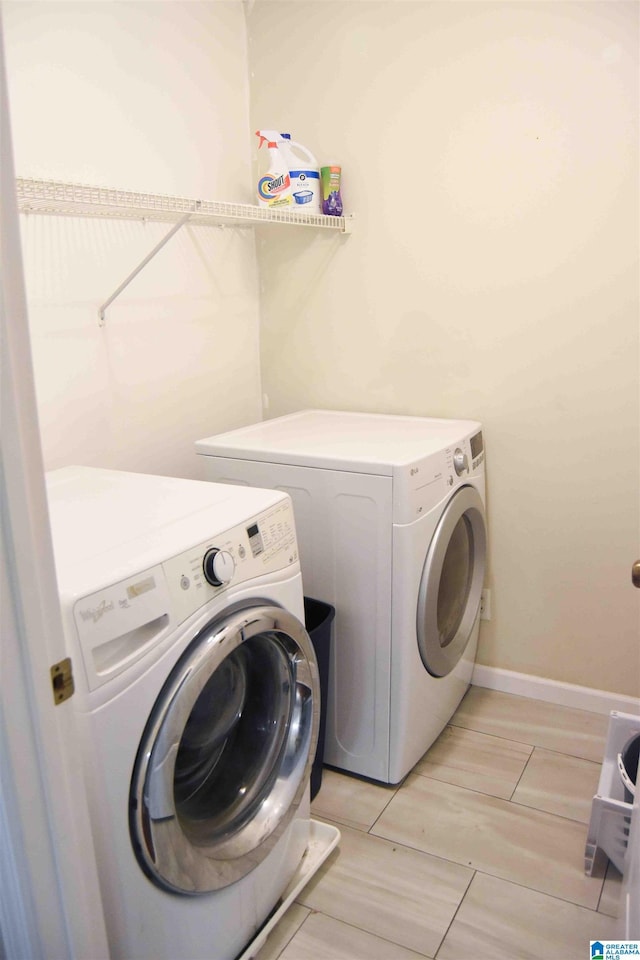 laundry room featuring baseboards, laundry area, and washer and dryer