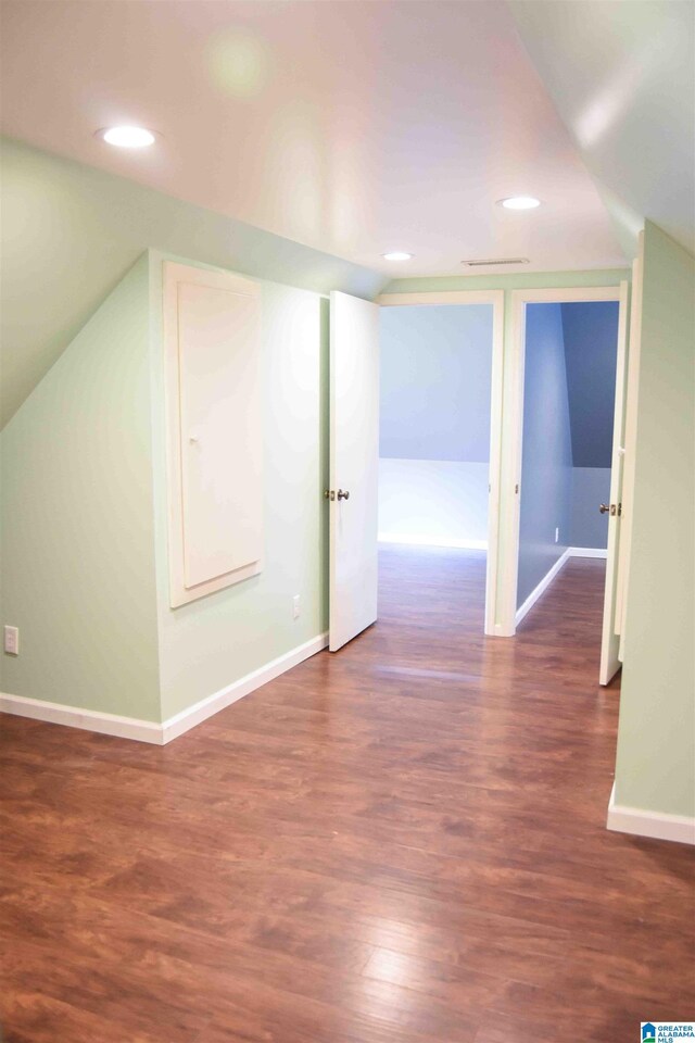 additional living space with dark wood-style floors, recessed lighting, lofted ceiling, and baseboards