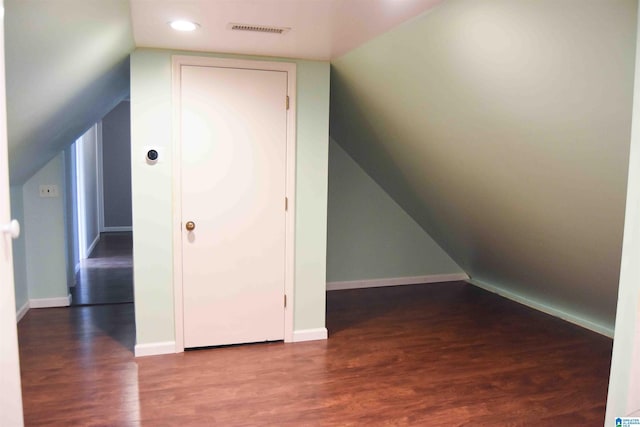 bonus room with baseboards, visible vents, dark wood finished floors, lofted ceiling, and recessed lighting