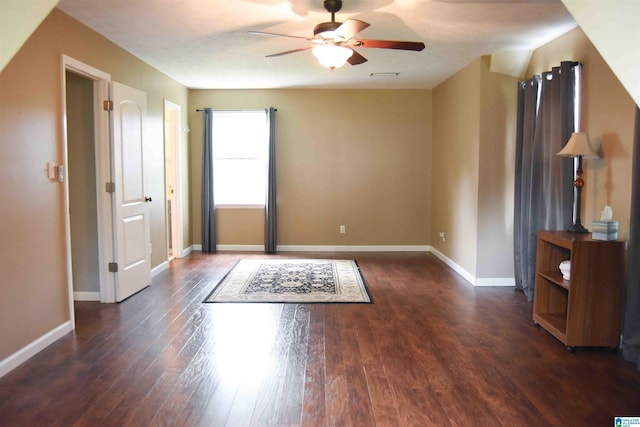 empty room with visible vents, dark wood finished floors, baseboards, and ceiling fan