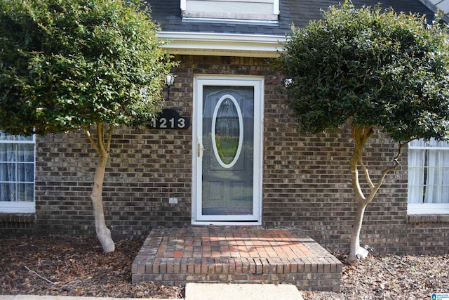 property entrance with brick siding