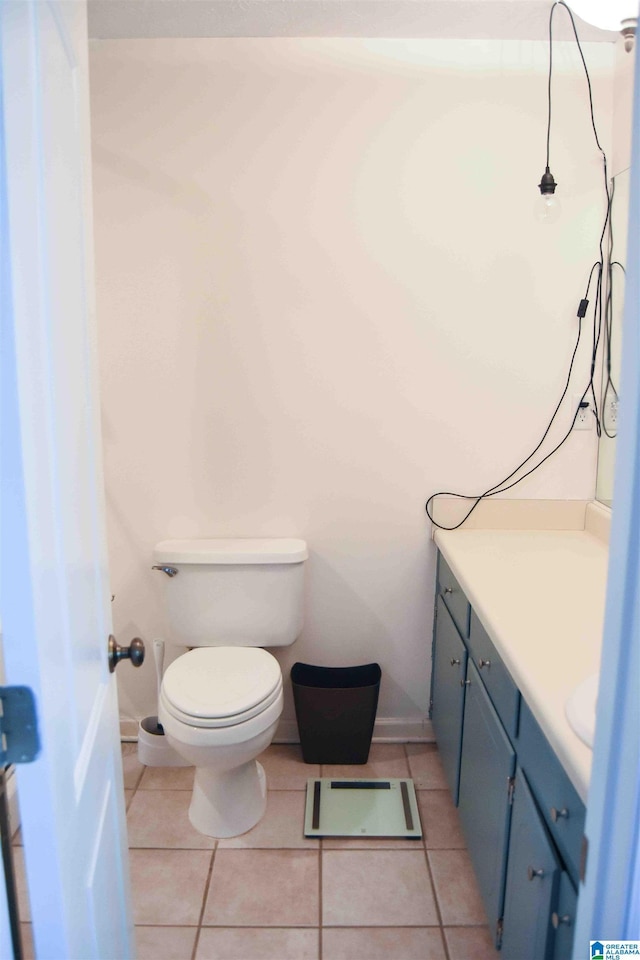 bathroom with vanity, toilet, and tile patterned floors