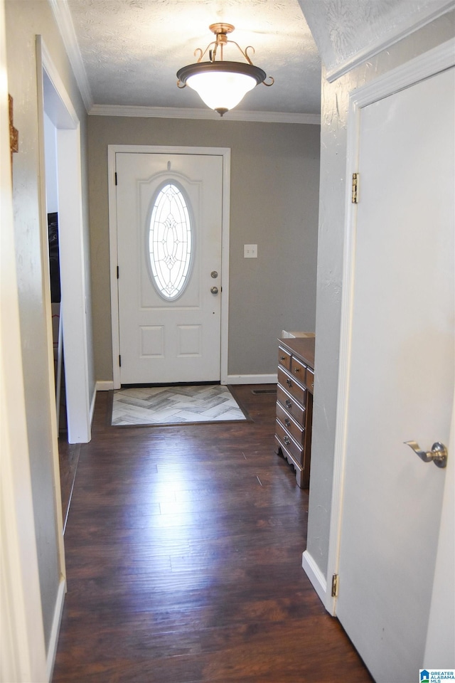 entryway featuring a textured ceiling, dark wood-style flooring, baseboards, and crown molding