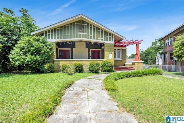 view of front facade featuring a front yard and a pergola