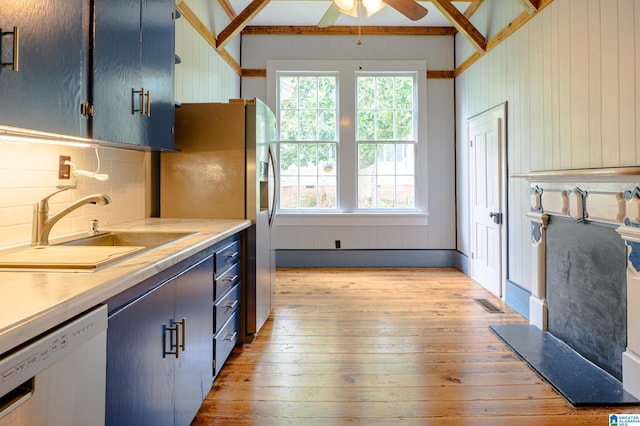 kitchen with sink, white dishwasher, a healthy amount of sunlight, and light hardwood / wood-style flooring