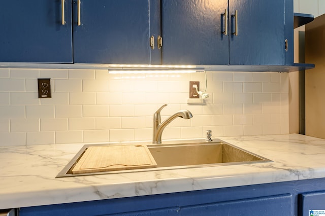 kitchen with blue cabinetry and sink