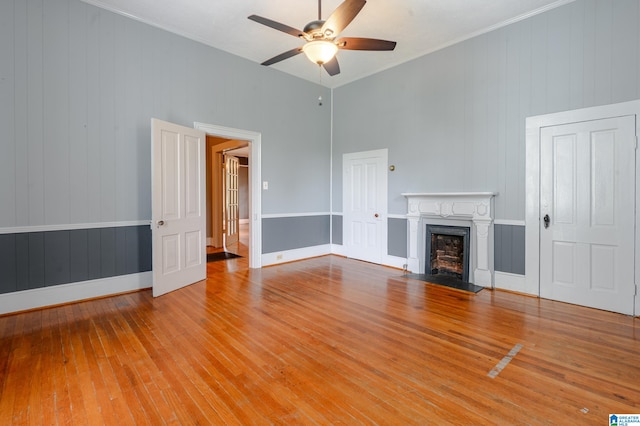 unfurnished living room with light hardwood / wood-style flooring and ceiling fan