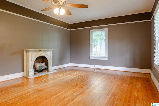 unfurnished living room with hardwood / wood-style floors, ceiling fan, and crown molding