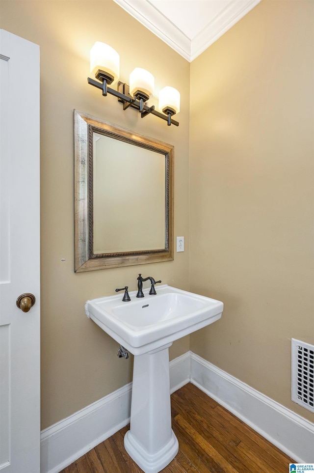 bathroom with crown molding and wood-type flooring