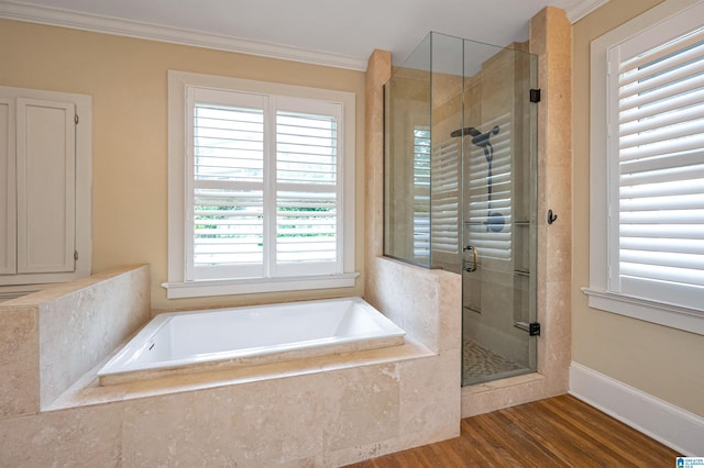 bathroom with ornamental molding, separate shower and tub, and hardwood / wood-style floors