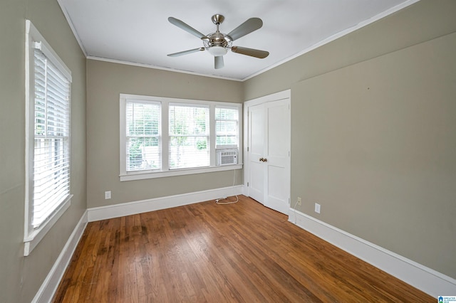 spare room with hardwood / wood-style flooring, ceiling fan, and ornamental molding