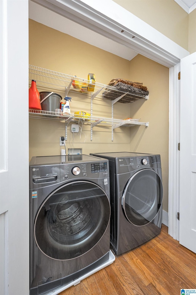 laundry room featuring washer and dryer and hardwood / wood-style floors