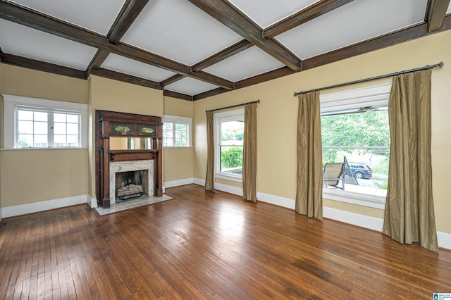 unfurnished living room featuring coffered ceiling, dark hardwood / wood-style floors, and a fireplace